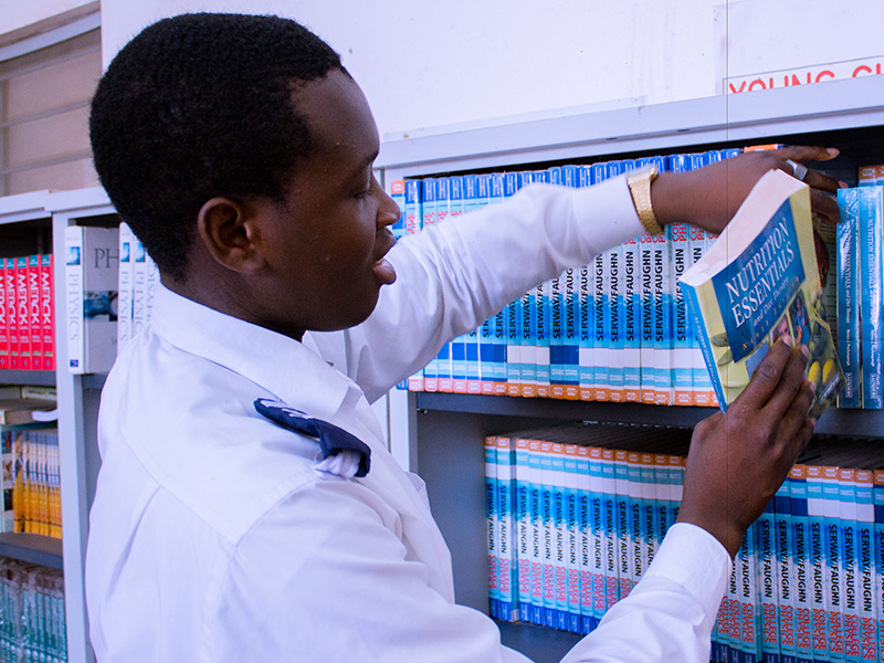 Student pulling out a book